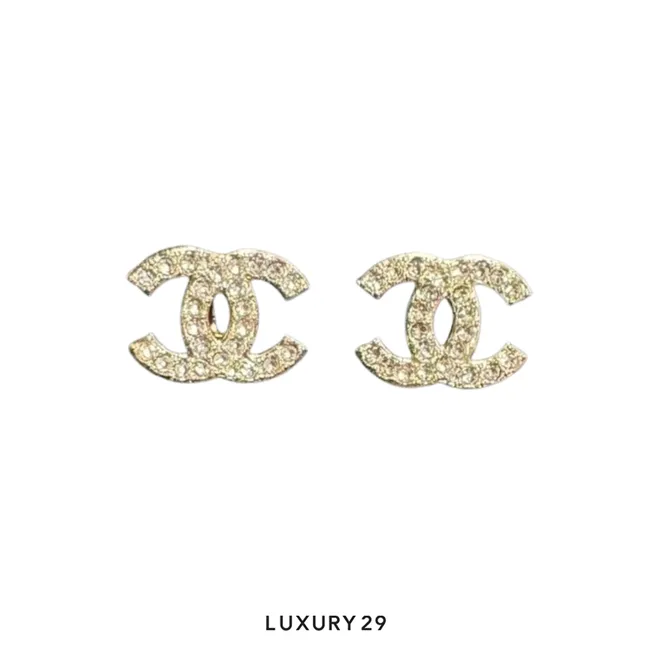 Chanel earrings featuring a gold-tone textured CC logo set with pearls and crystals