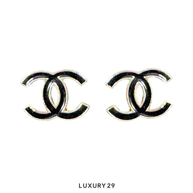 Chanel earrings feature a prominent gold-plated CC logo design