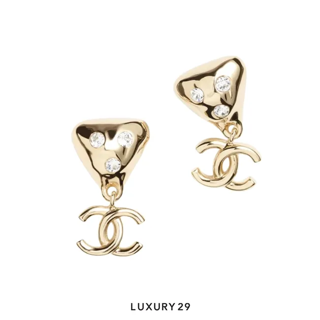 Chanel earrings feature a crystal-embellished heart-shaped drop with the signature CC logo