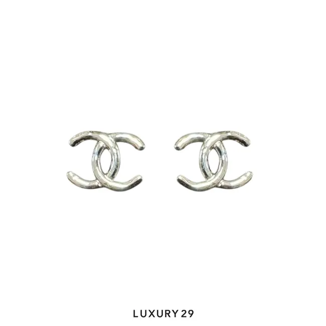 Chanel earrings feature the iconic interlocking CC logo in a polished Silver finish