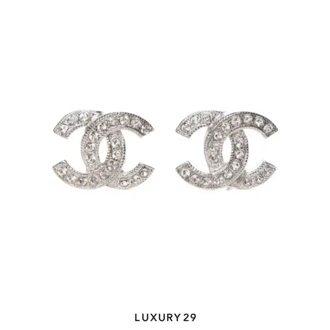 Chanel stud earrings feature the iconic Silver-tone CC logo embellished with sparkling crystals
