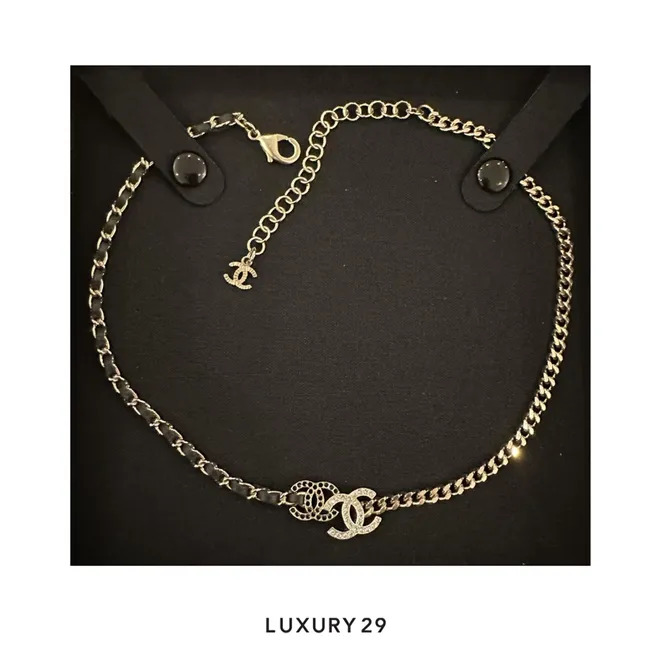 Chanel choker necklace features a mixed-metal design with a rhinestone-accented interlocking CC logo
